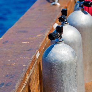 scuba diving equipment on boat near blue ocean
