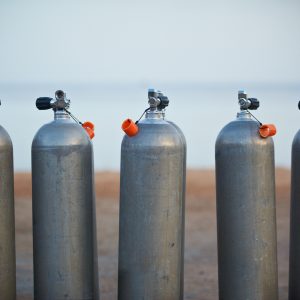 Collection of grey scuba diving air oxygen tanks.